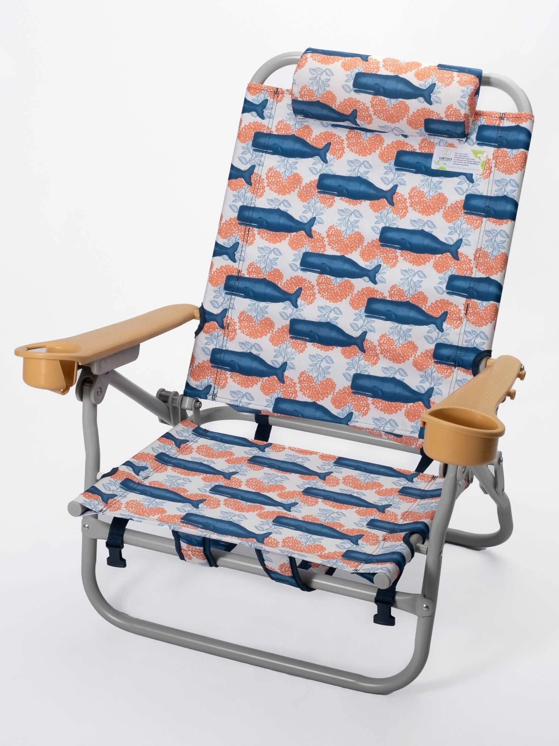Folding beach chair with a marine-themed fabric featuring blue whales and coral patterns, wooden armrests, and an adjustable headrest.