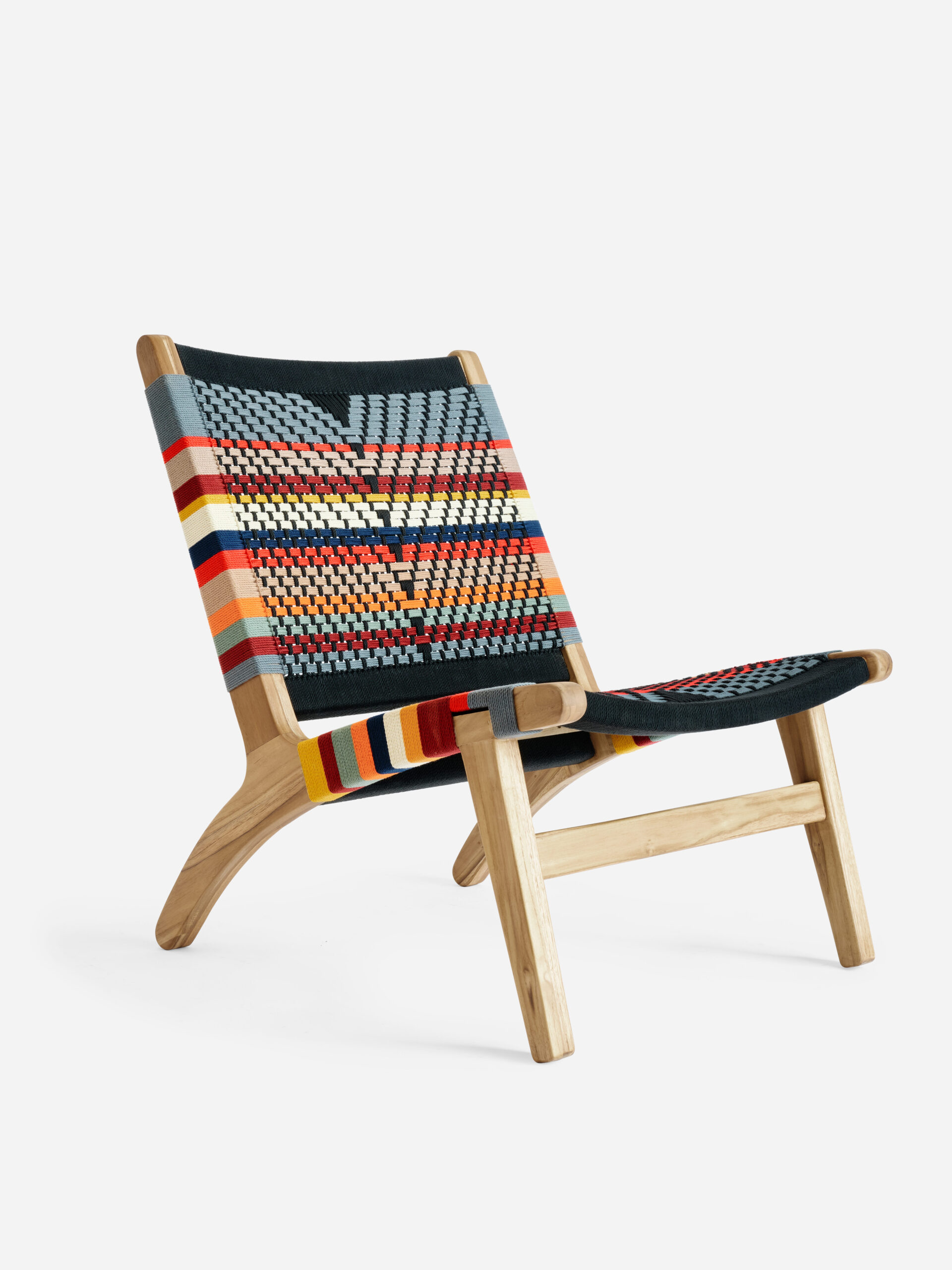 A handwoven lounge chair with a yellow, red, orange, blue and white woven pattern from MasayaCo. 