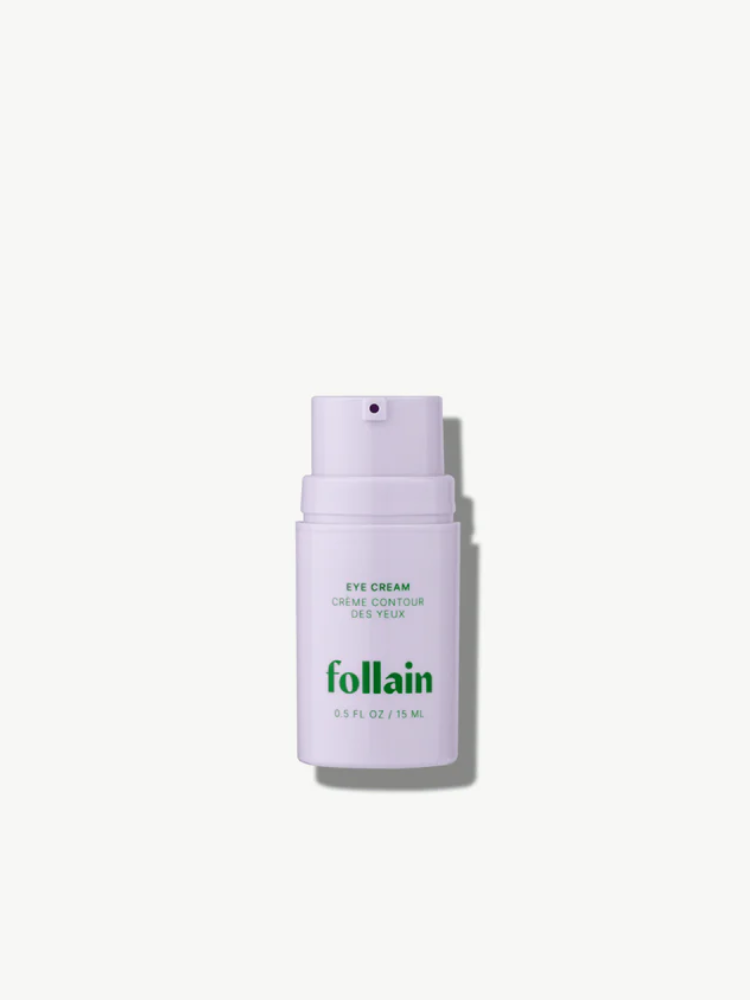A white pump bottle labeled "Follain Eye Cream, 0.5 fl oz / 15 ml" stands upright against a plain white background.